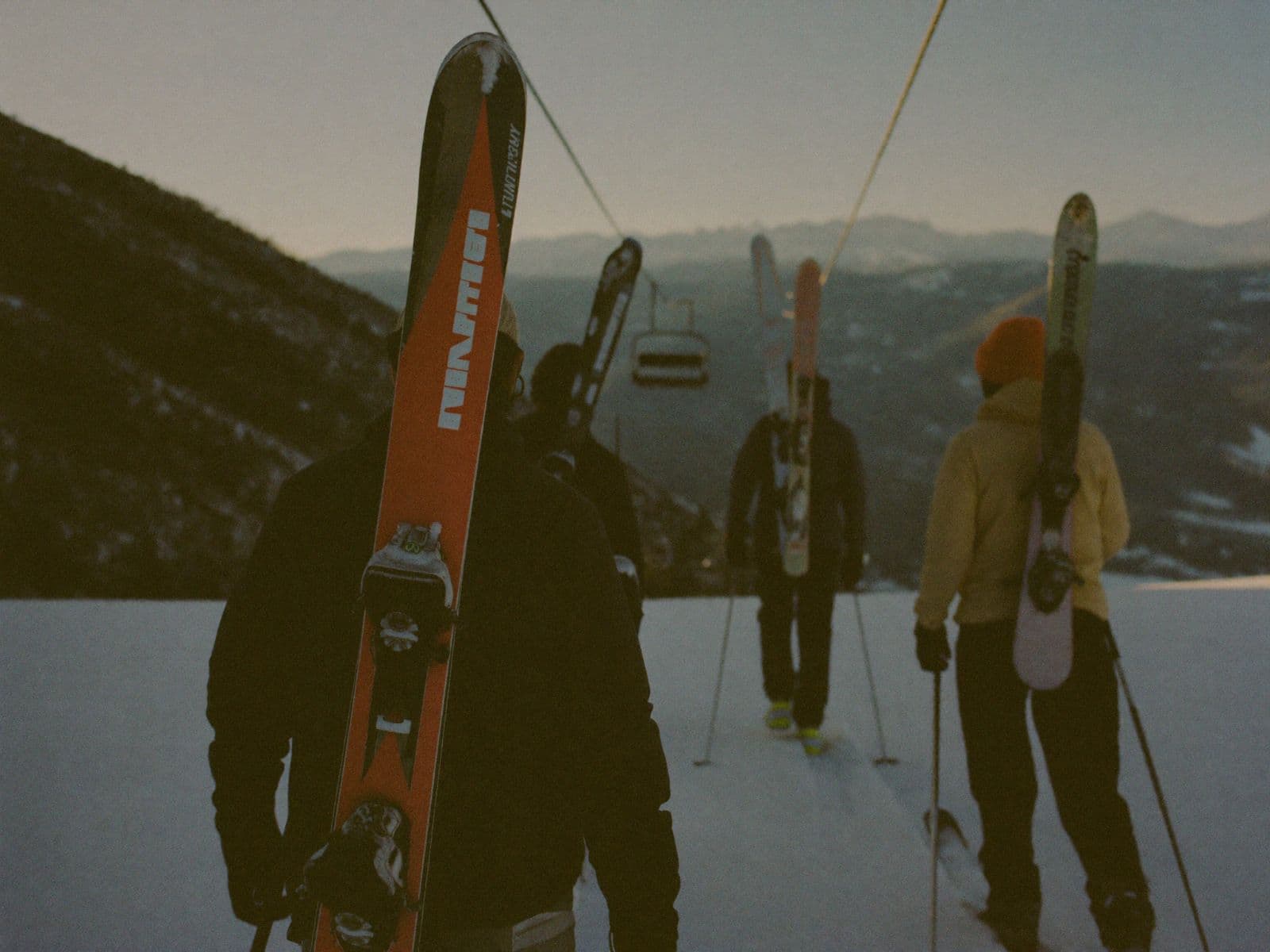 Ski crew walking toward the lift at sunrise